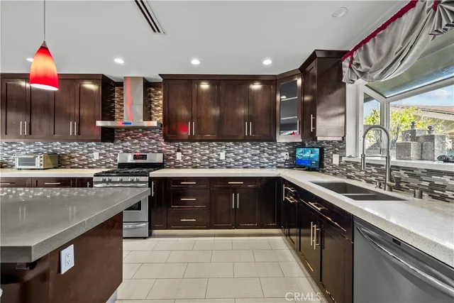 a large kitchen with stainless steel appliances granite countertop a sink counter space cabinets and a large window