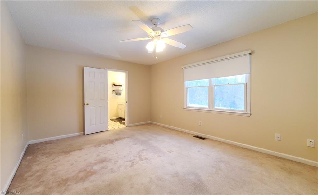 2301 Griffith Road Winston-Salem, NC 27103 - Photo 18 of 50 Primary bedroom with closet and bathroom at the end.