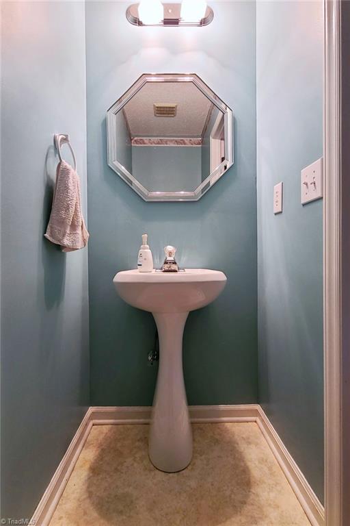 2301 Griffith Road Winston-Salem, NC 27103 - Photo 29 of 50 Half bath located in the hall located behind the laundry.