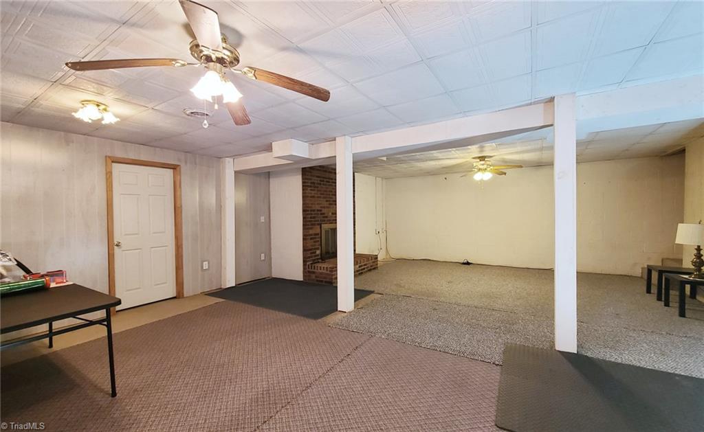 2301 Griffith Road Winston-Salem, NC 27103 - Photo 32 of 50 Heated basement area with adjacent storage room towards the back of the fireplace