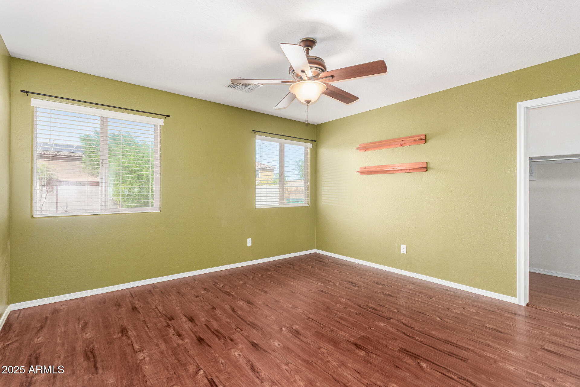 40214 West Lococo Street Maricopa, AZ 85138 - Photo 11 of 31 a view of room with window ceiling fan and hardwood floor