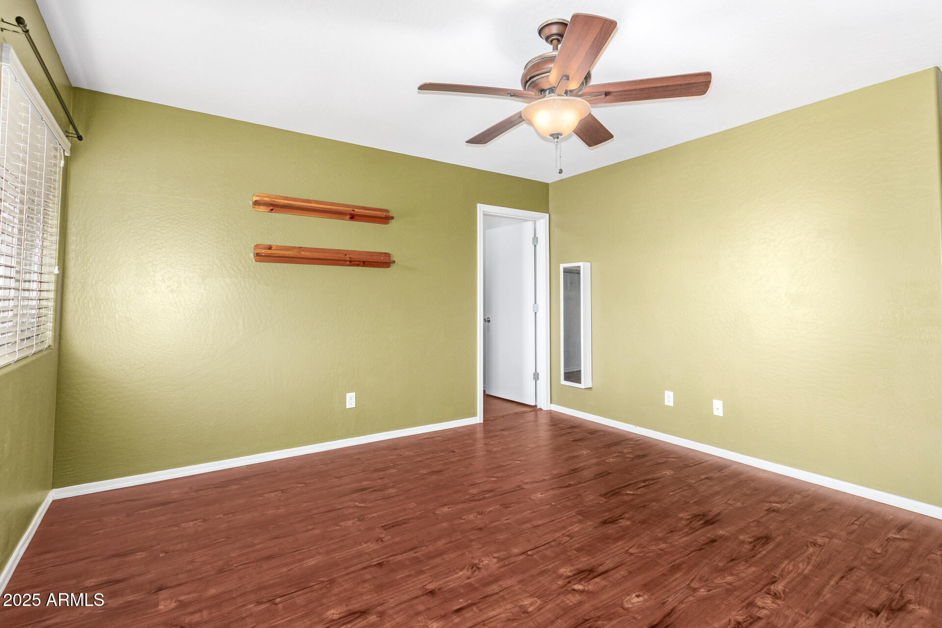 40214 West Lococo Street Maricopa, AZ 85138 - Photo 13 of 31 a view of a big room with wooden floor