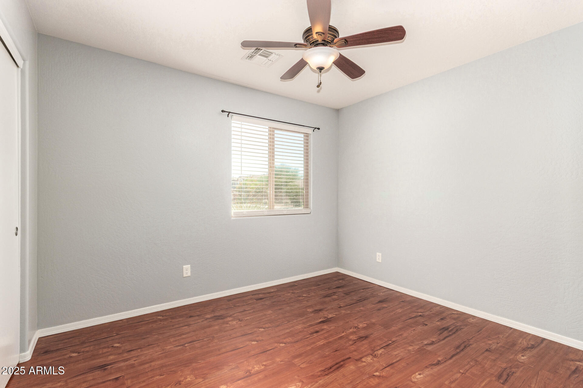 40214 West Lococo Street Maricopa, AZ 85138 - Photo 15 of 31 an empty room with a window and a ceiling fan
