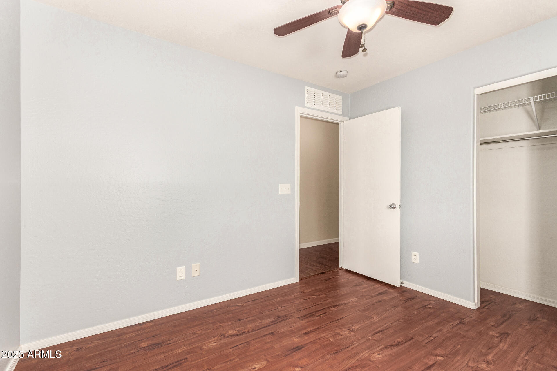 40214 West Lococo Street Maricopa, AZ 85138 - Photo 16 of 31 a view of an empty room with wooden floor