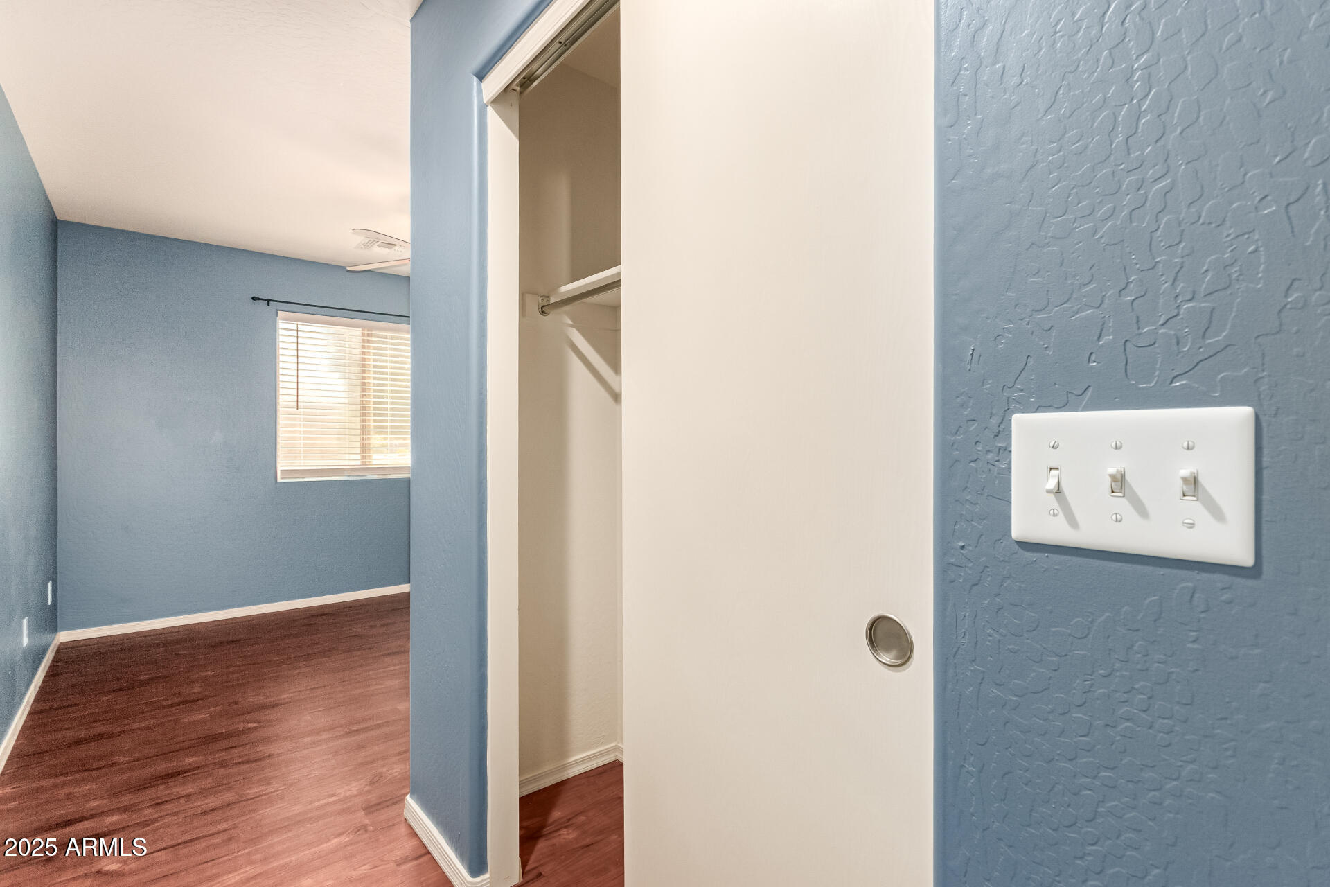 40214 West Lococo Street Maricopa, AZ 85138 - Photo 17 of 31 a view of a hallway with wooden floor