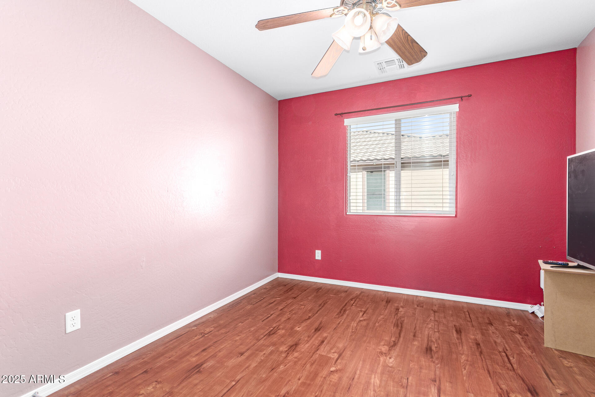 40214 West Lococo Street Maricopa, AZ 85138 - Photo 20 of 31 a view of empty room with wooden floor and fan