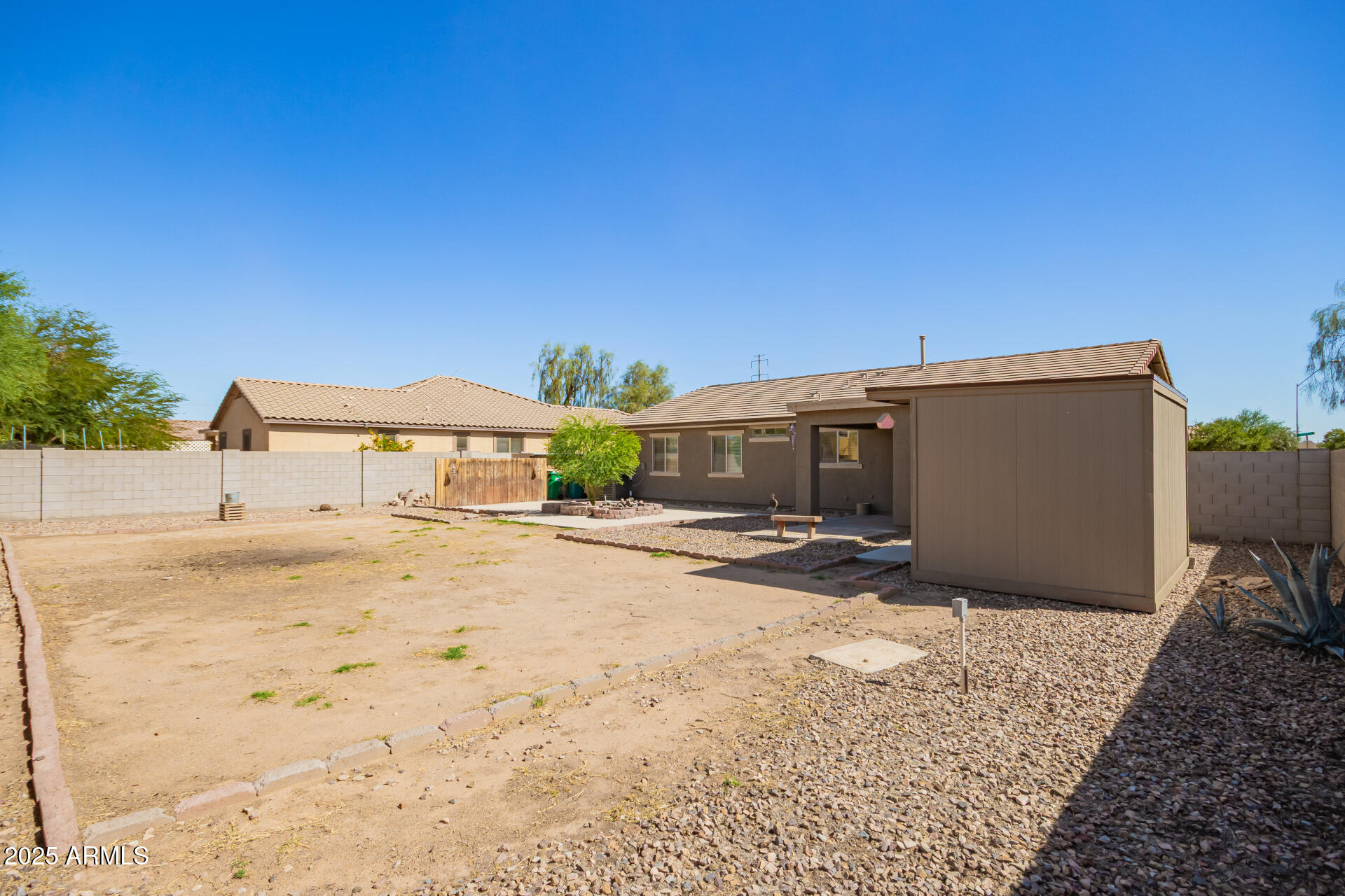 40214 West Lococo Street Maricopa, AZ 85138 - Photo 26 of 31 a view of a dirt road and a building