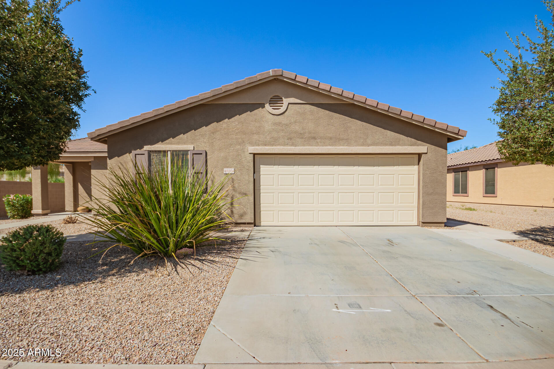 40214 West Lococo Street Maricopa, AZ 85138 - Photo 30 of 31 a front view of a house with a yard and garage