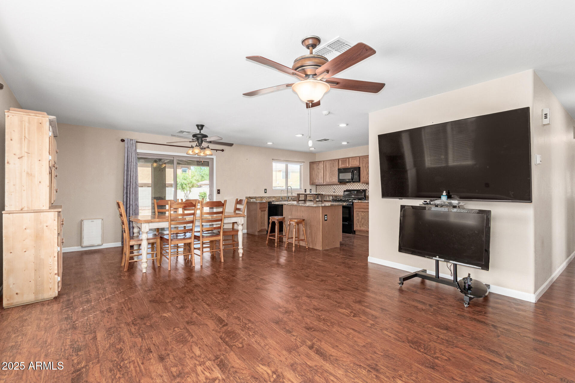 40214 West Lococo Street Maricopa, AZ 85138 - Photo 6 of 31 a living room with furniture and a flat screen tv