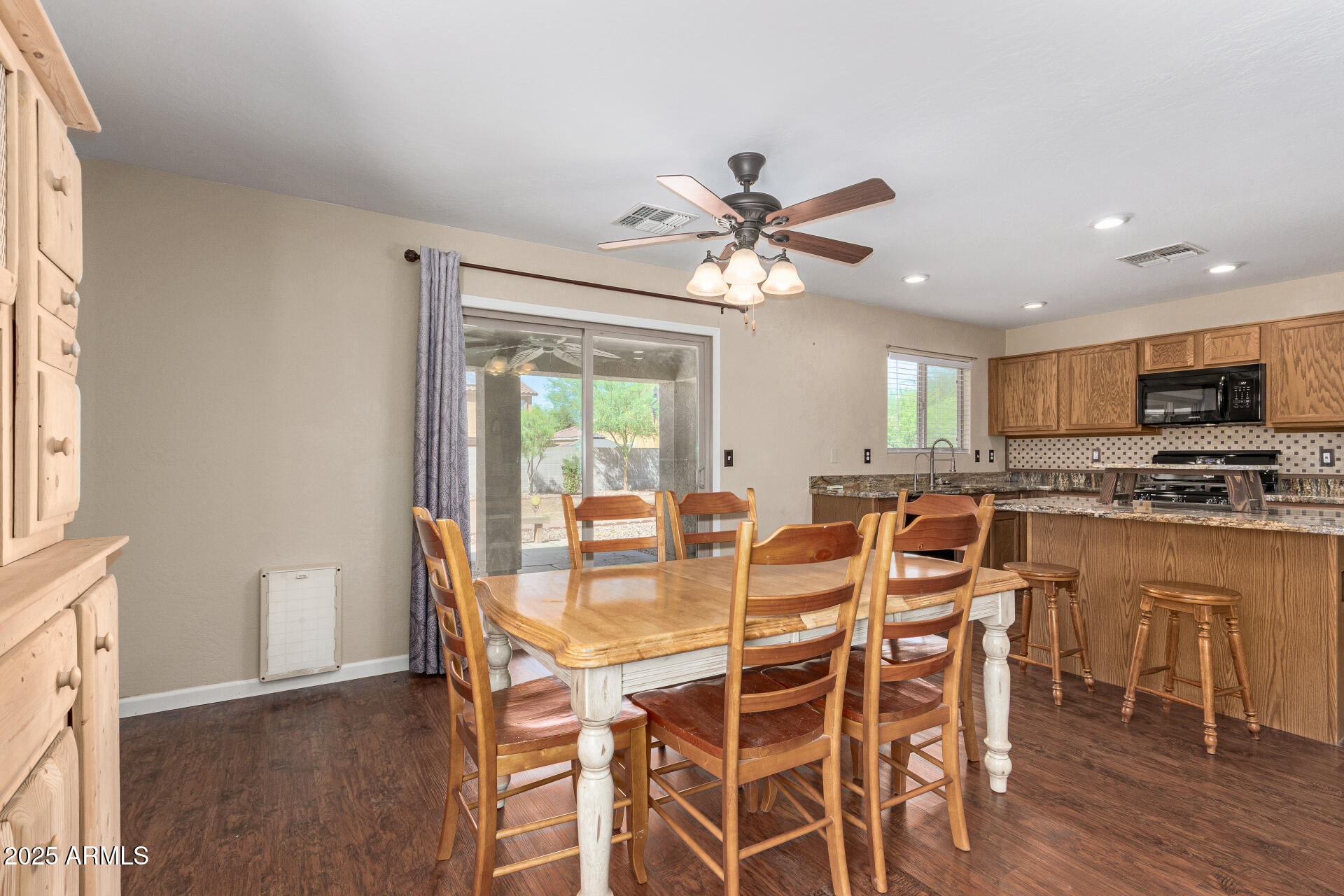 40214 West Lococo Street Maricopa, AZ 85138 - Photo 8 of 31 a view of a dining room with furniture window and wooden floor