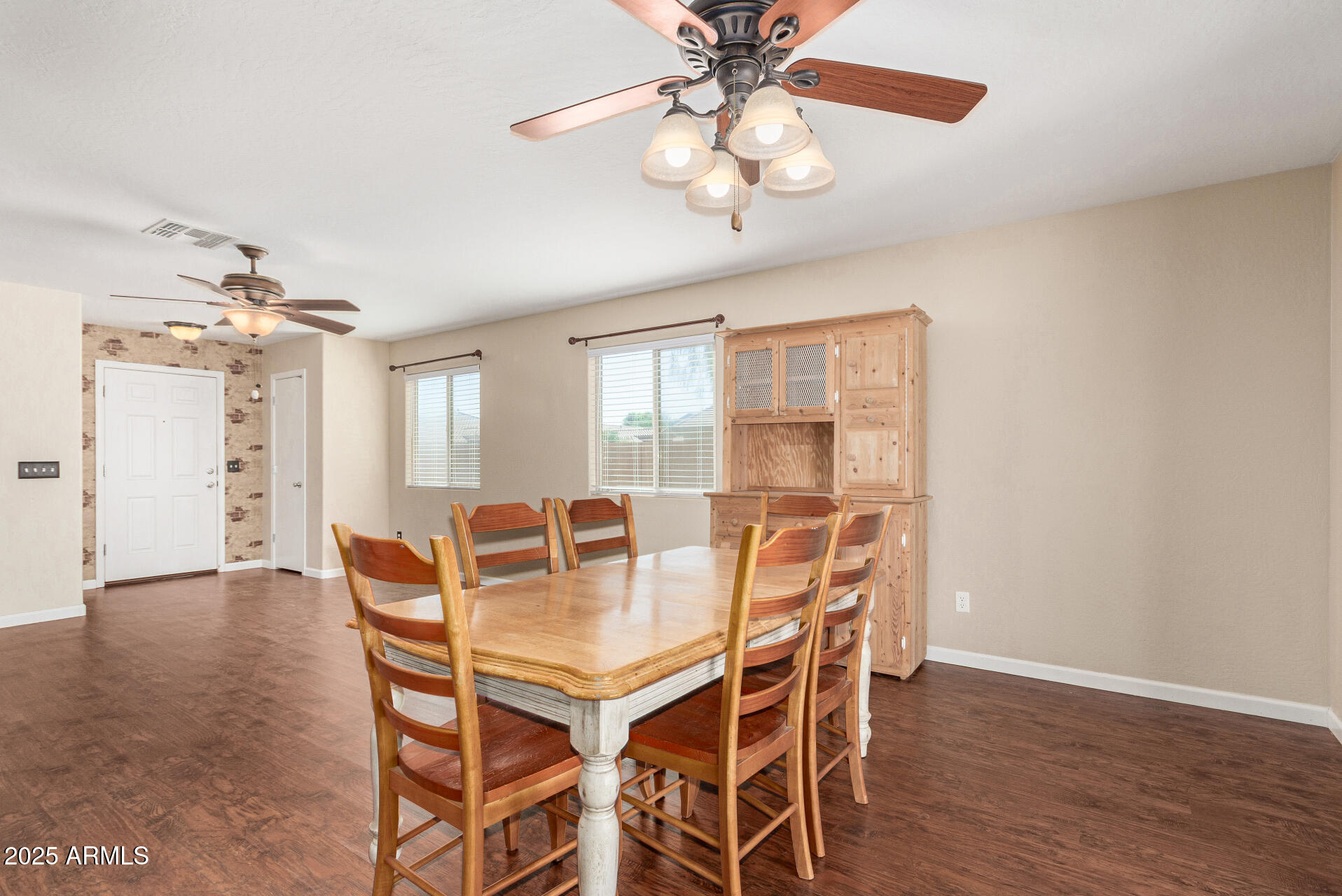 40214 West Lococo Street Maricopa, AZ 85138 - Photo 9 of 31 a view of a dining room with furniture and wooden floor