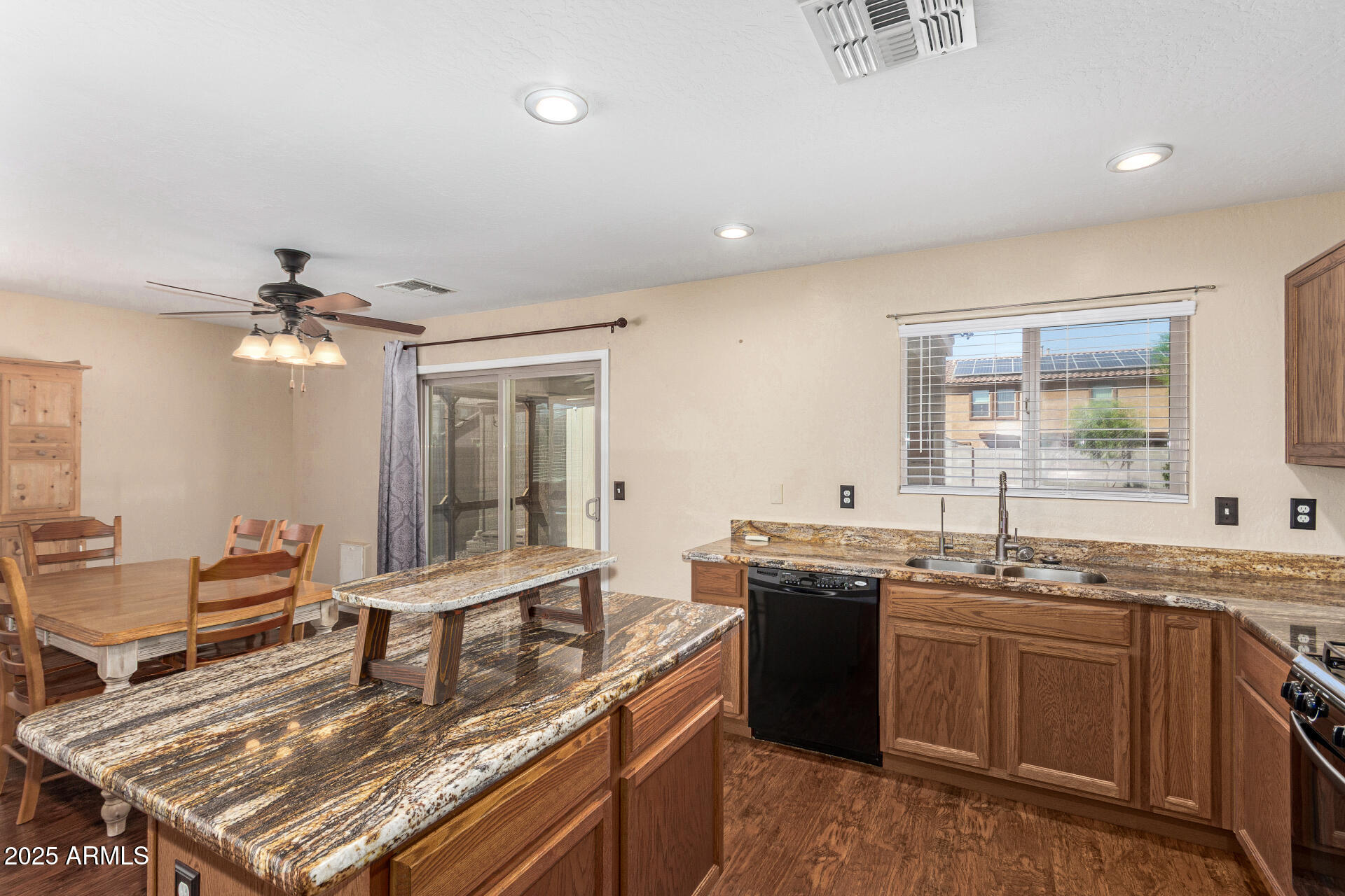 40214 West Lococo Street Maricopa, AZ 85138 - Photo 10 of 31 a kitchen with granite countertop a sink stove and cabinets