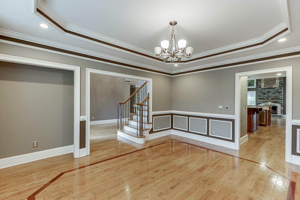 940 Chateau Forest Road Hoschton, GA 30548 - Photo 7 of 87 a view of an empty room with chandelier