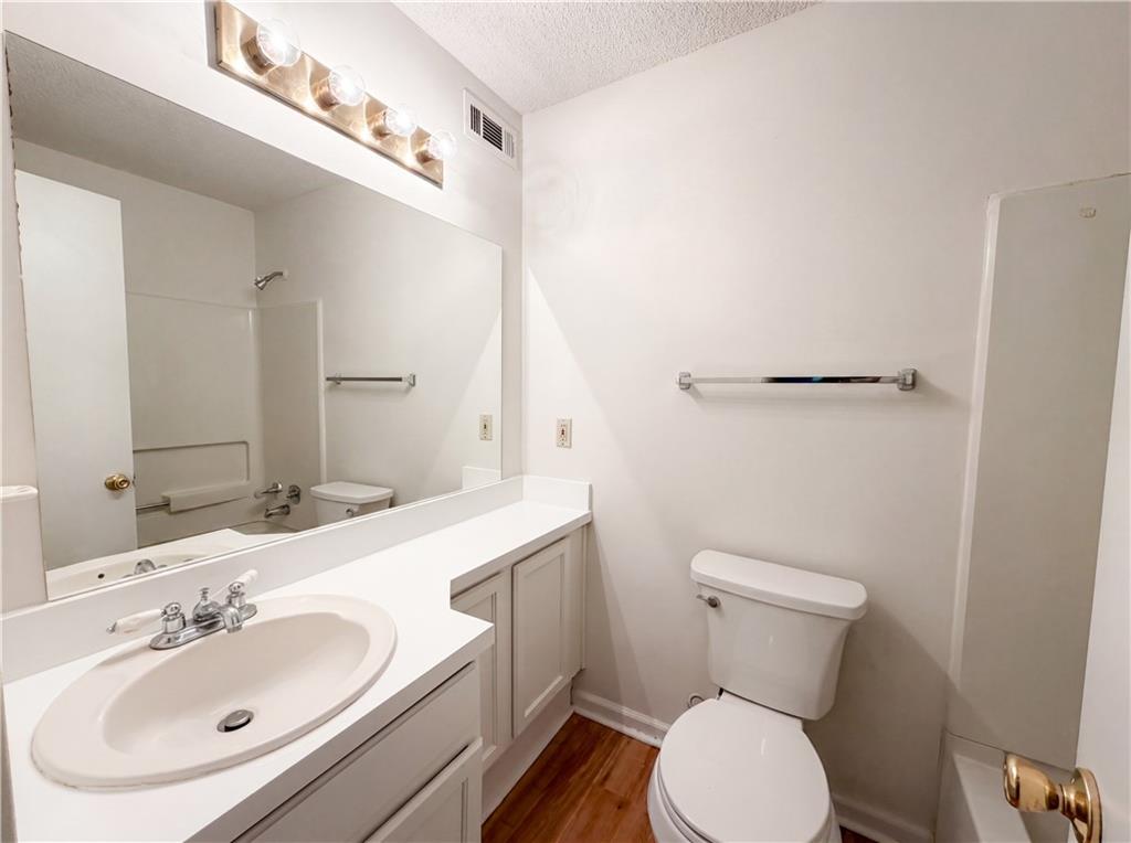 573 Cobblestone Trail Avondale Estates, GA 30002 - Photo 14 of 23 a bathroom with a sink mirror vanity and toilet