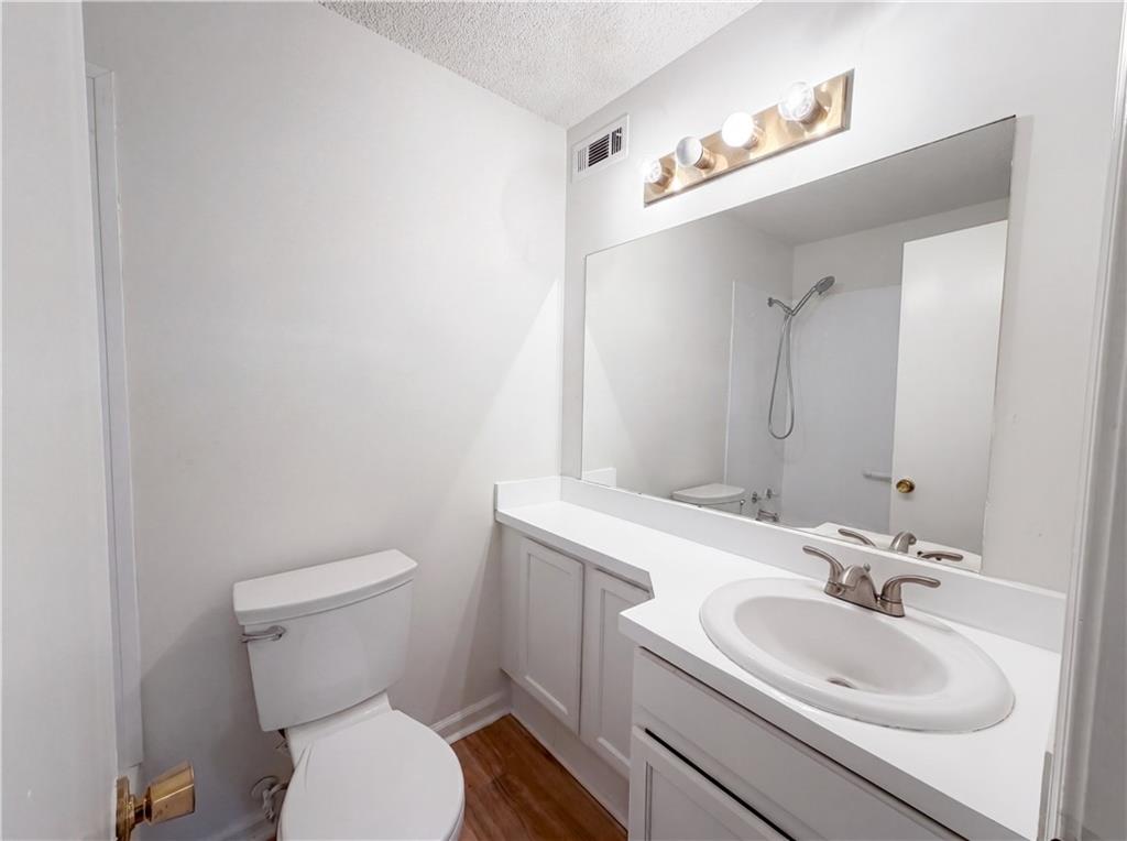 573 Cobblestone Trail Avondale Estates, GA 30002 - Photo 15 of 23 a bathroom with a sink a toilet and mirror