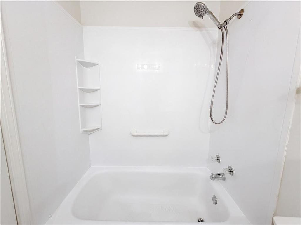573 Cobblestone Trail Avondale Estates, GA 30002 - Photo 17 of 23 a bathroom with a bath tub with a shower