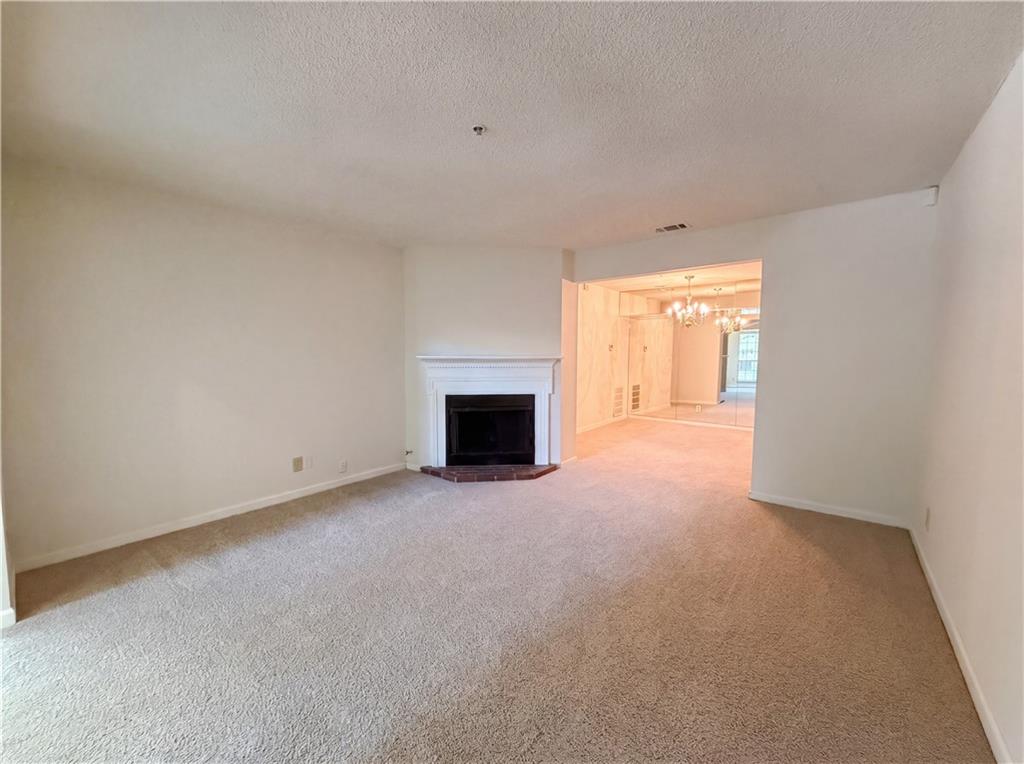 573 Cobblestone Trail Avondale Estates, GA 30002 - Photo 3 of 23 a view of an empty room with a fireplace and a window