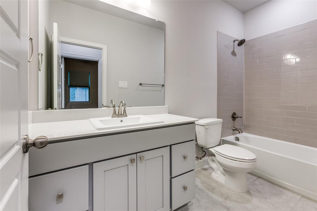 1888 Strand Street Dallas, TX 75234 - Photo 11 of 13 Bathroom featuring a single vanity with white cabinetry, a rectangular undermount sink, and a white countertop