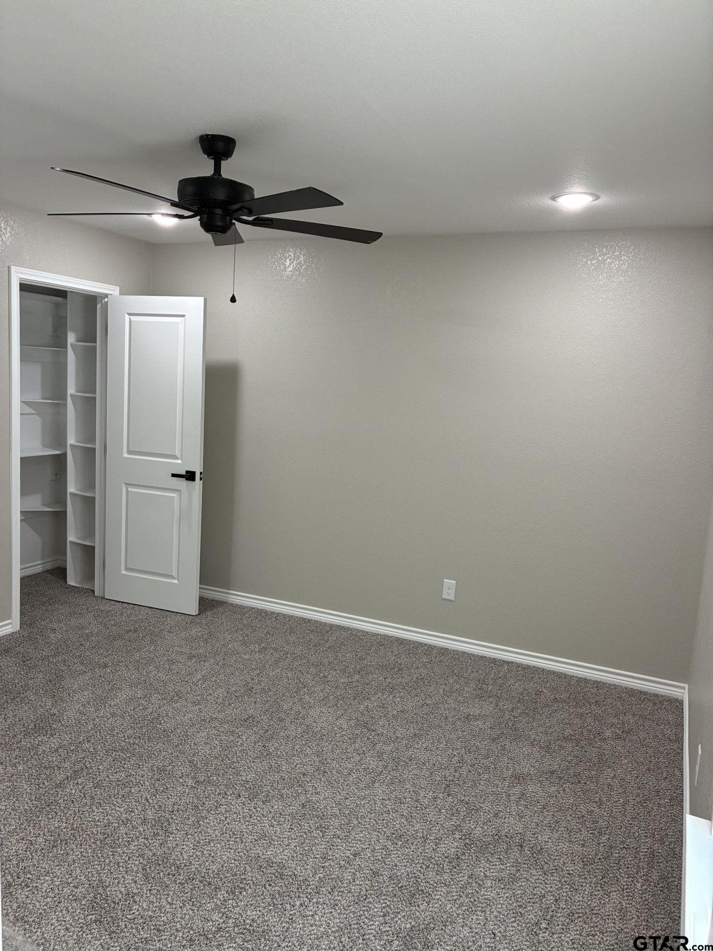 1607 North Ross Avenue Tyler, TX 75702 - Photo 4 of 10 an empty room with closet and windows