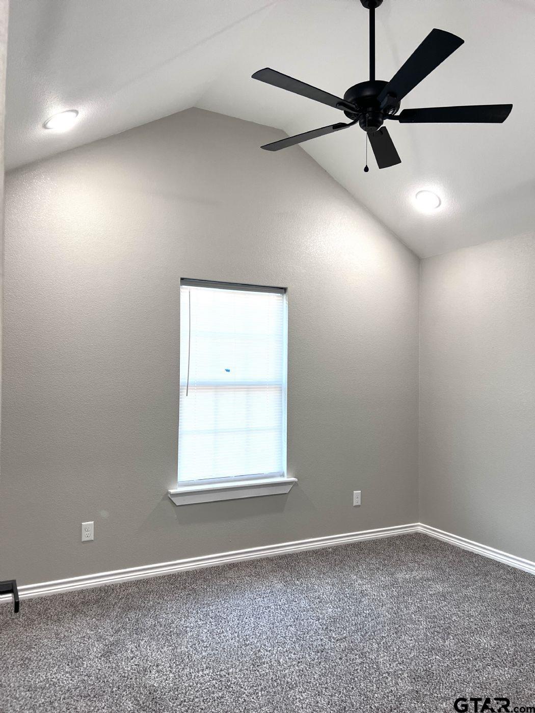 1607 North Ross Avenue Tyler, TX 75702 - Photo 8 of 10 an empty room with a window and a fan