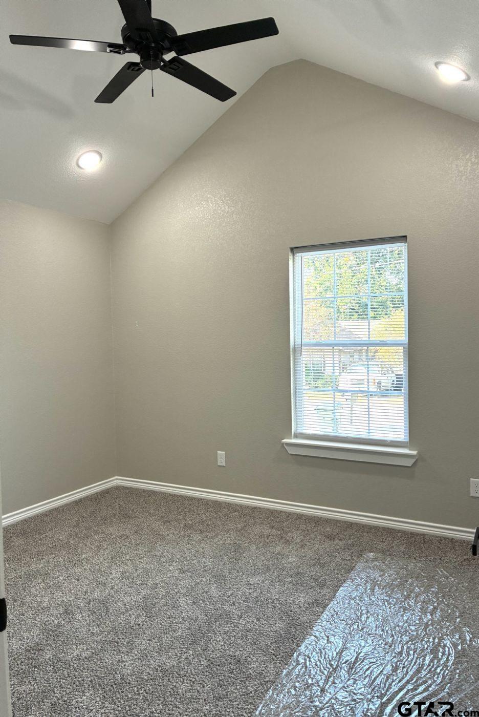 1607 North Ross Avenue Tyler, TX 75702 - Photo 9 of 10 an empty room with a window and a fan