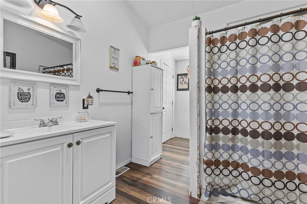 33945 Red Mountain Road Hemet, CA 92544 - Photo 19 of 30 a bathroom with a sink and a mirror