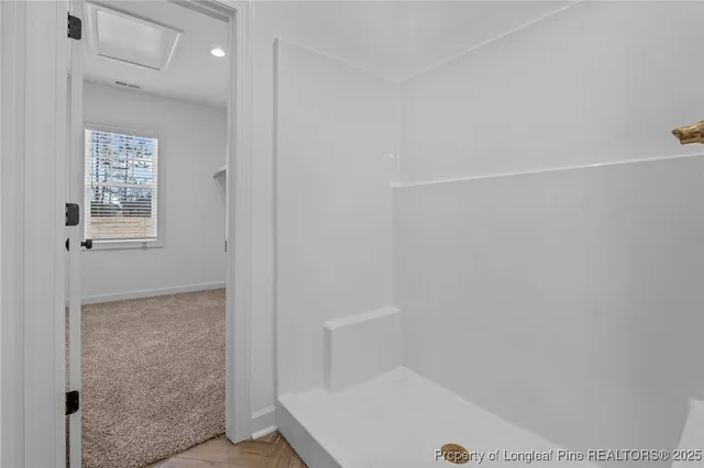 a bathroom with a bathtub and shower