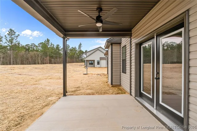 a view of house with yard and mountain in the background