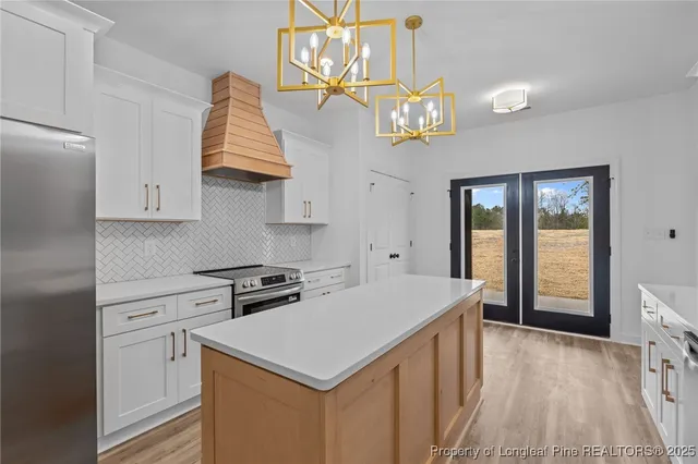 a kitchen that has a lot of cabinets in it