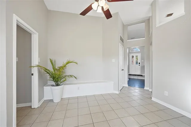 a spacious bathroom with a tub sink and mirror