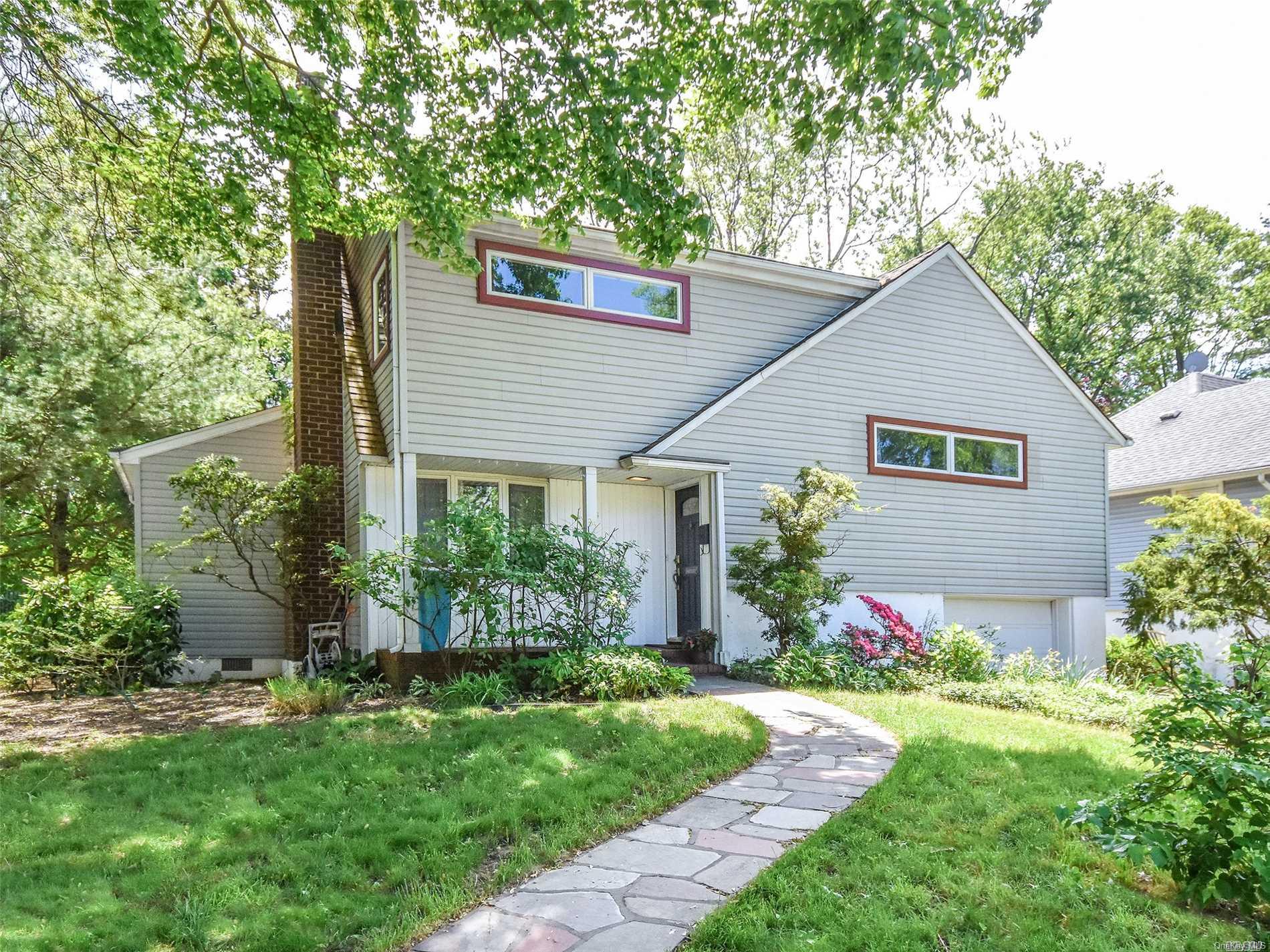 35 Revere Road Port Washington, NY 11050 - Photo 1 of 1 a front view of house with a garden