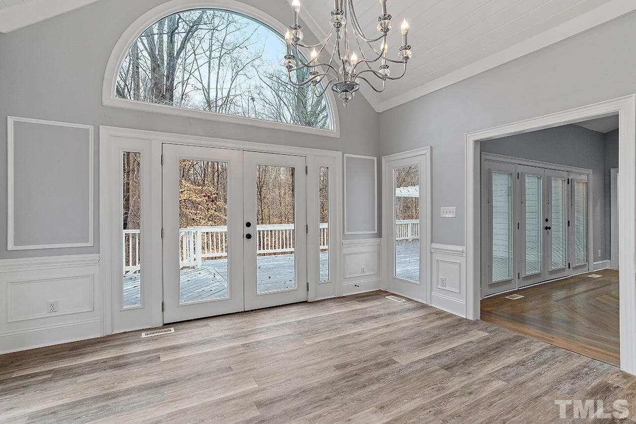 9132 Sutherland Court Raleigh, NC 27615 - Photo 12 of 36 a view of a livingroom with wooden floor and a large window