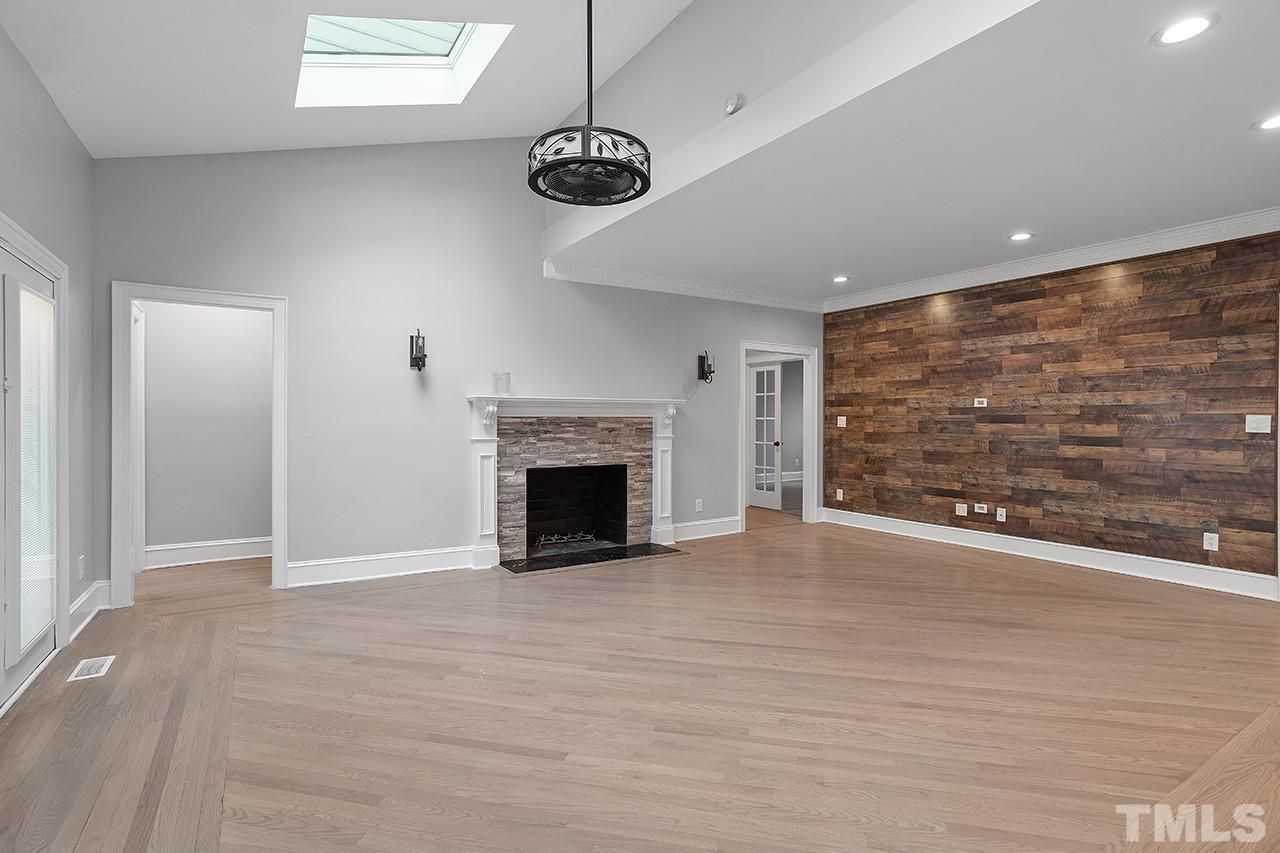 9132 Sutherland Court Raleigh, NC 27615 - Photo 13 of 36 a view of an empty room with a fireplace