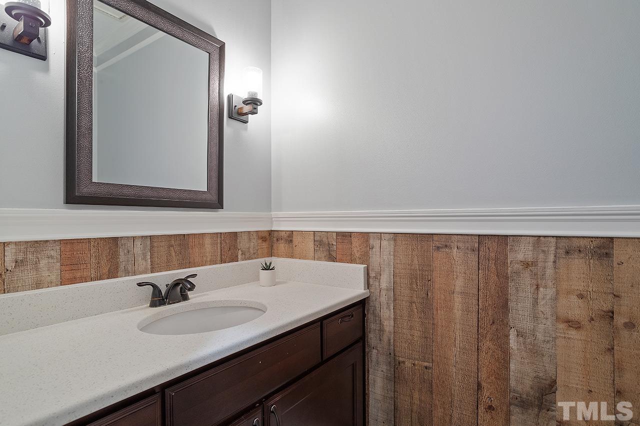 9132 Sutherland Court Raleigh, NC 27615 - Photo 23 of 36 a bathroom with a sink and a mirror