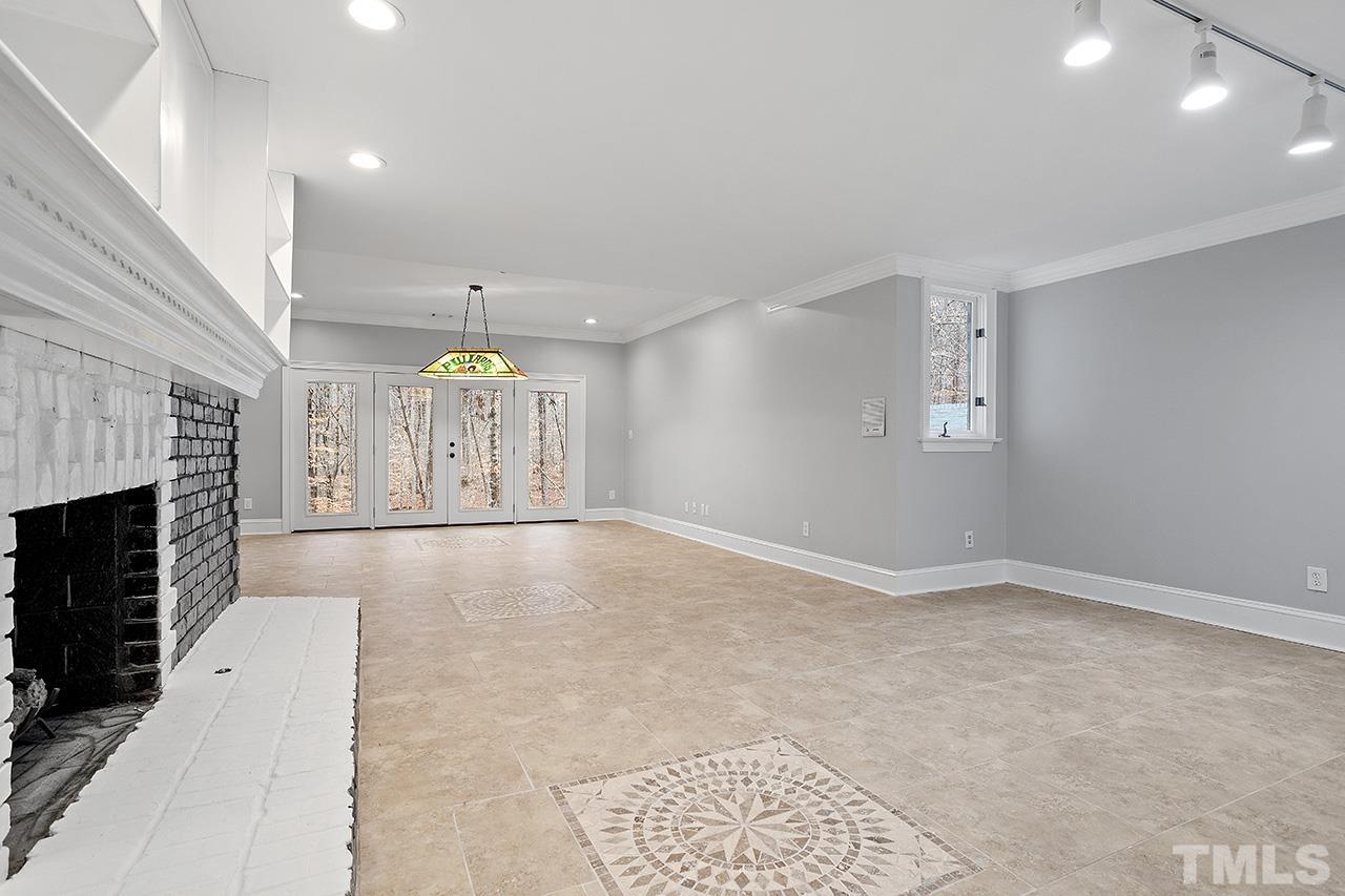 9132 Sutherland Court Raleigh, NC 27615 - Photo 28 of 36 an empty room with windows and fireplace
