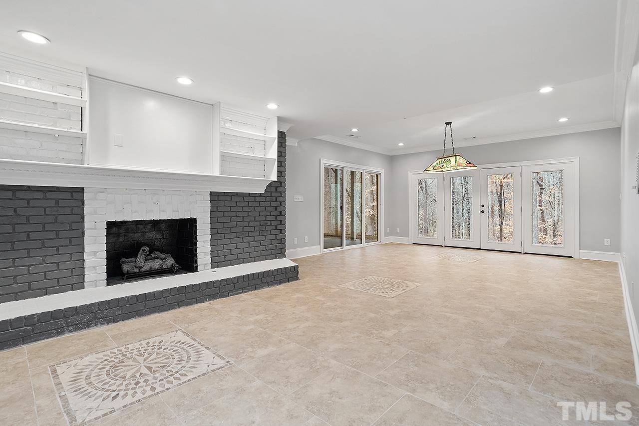 9132 Sutherland Court Raleigh, NC 27615 - Photo 29 of 36 a view of an empty room with a fireplace
