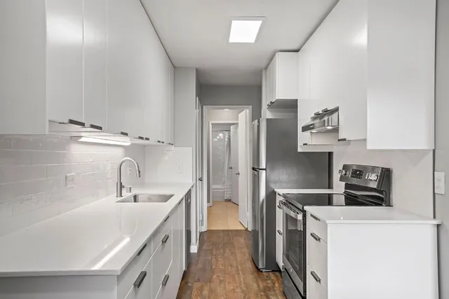 a kitchen with a sink stove and refrigerator