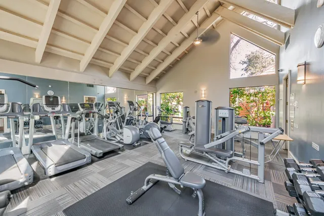 a living room with lots of furniture and a dining table with wooden floor