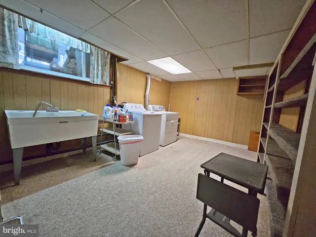 a living room with furniture a fireplace and large windows