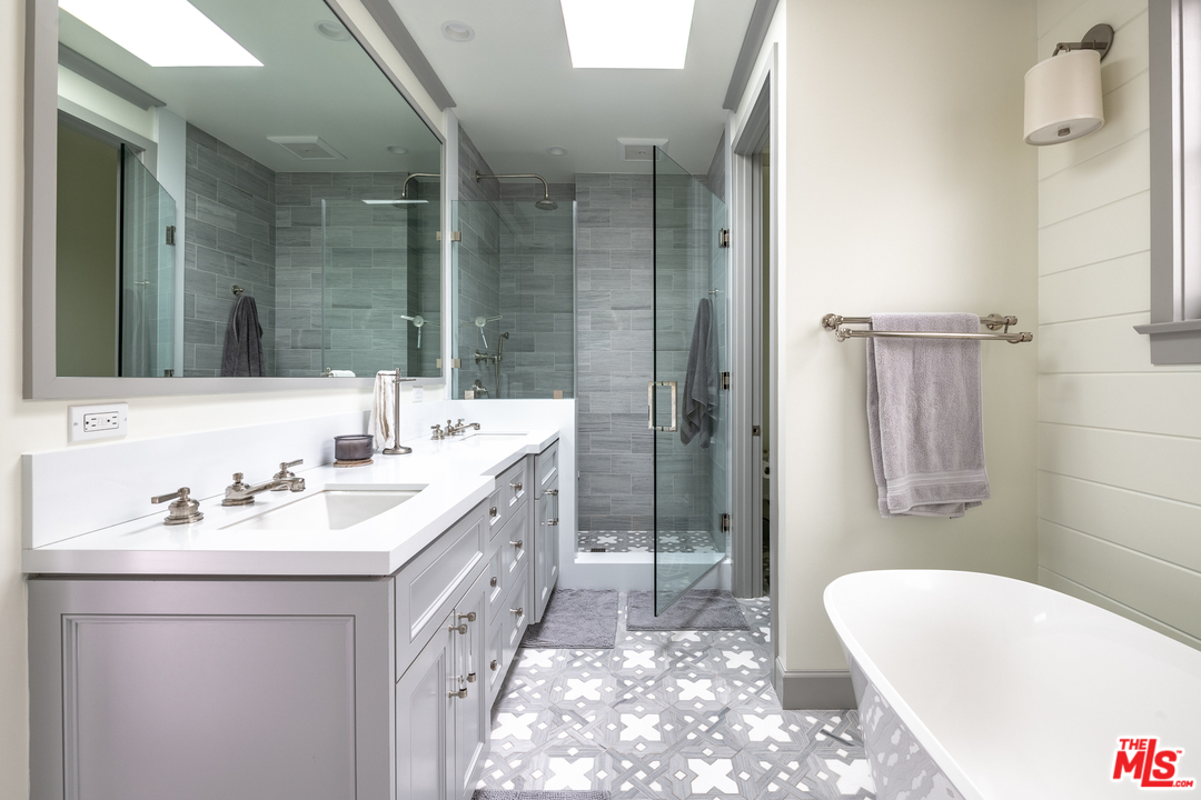 703 Bayview Drive Manhattan Beach, CA 90266 - Photo 11 of 30 a bathroom with a double vanity sink mirror and bathtub