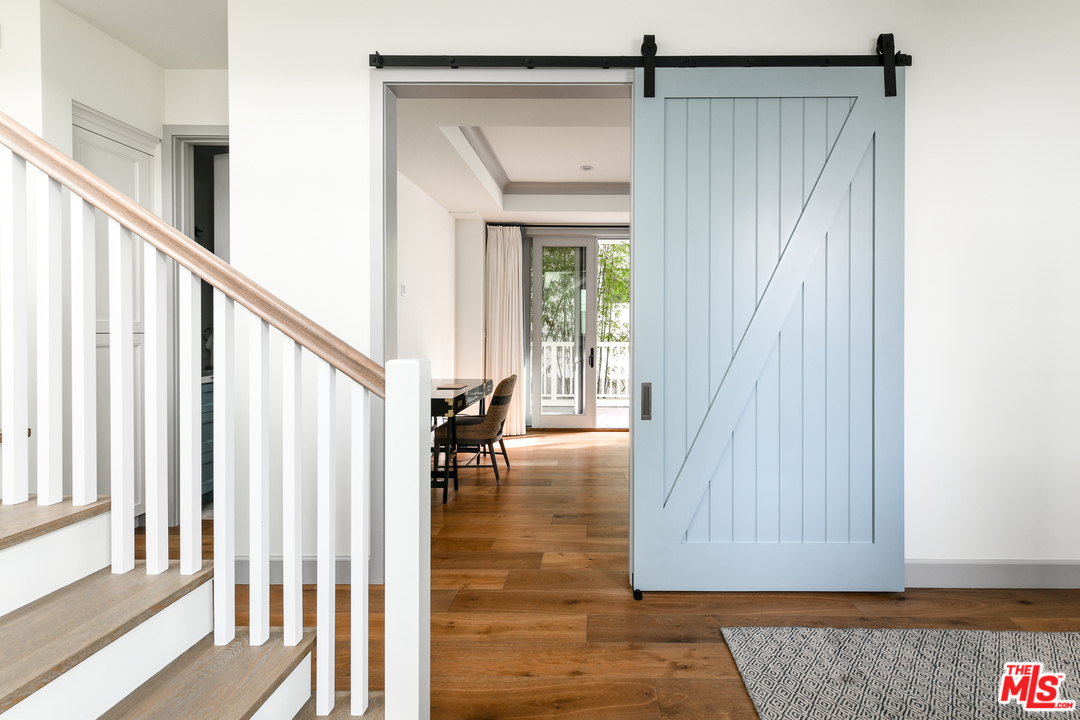 703 Bayview Drive Manhattan Beach, CA 90266 - Photo 18 of 30 a view of a hallway with wooden floor and staircase