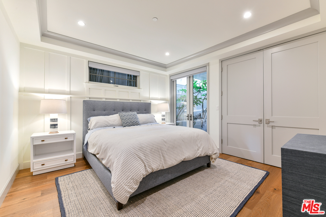 703 Bayview Drive Manhattan Beach, CA 90266 - Photo 19 of 30 a bedroom with a large bed and wooden floor