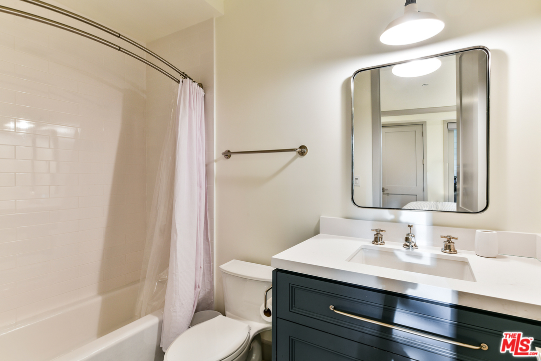 703 Bayview Drive Manhattan Beach, CA 90266 - Photo 21 of 30 a bathroom with a sink and a mirror
