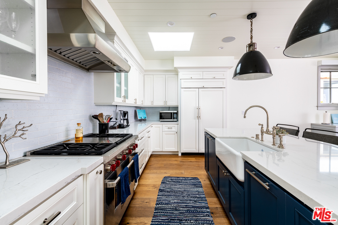 703 Bayview Drive Manhattan Beach, CA 90266 - Photo 8 of 30 a kitchen with a sink a stove and cabinets