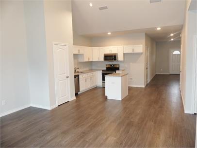8071 County Road, Unit 436 Princeton, TX 75407 - Photo 2 of 8 a kitchen with stainless steel appliances a refrigerator sink and stove