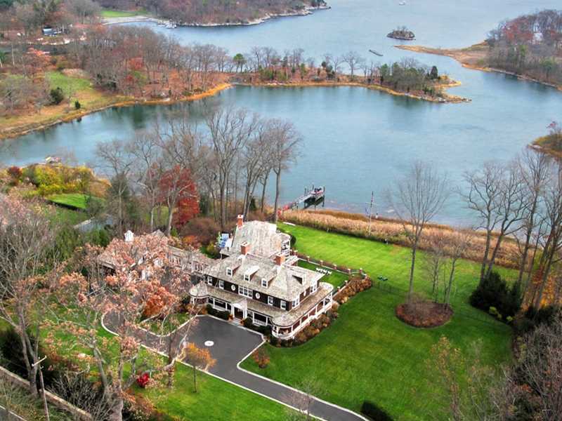 107 Long Neck Point Road Darien, CT 06820 - Photo 1 of 25 an aerial view of a house with a yard and lake view