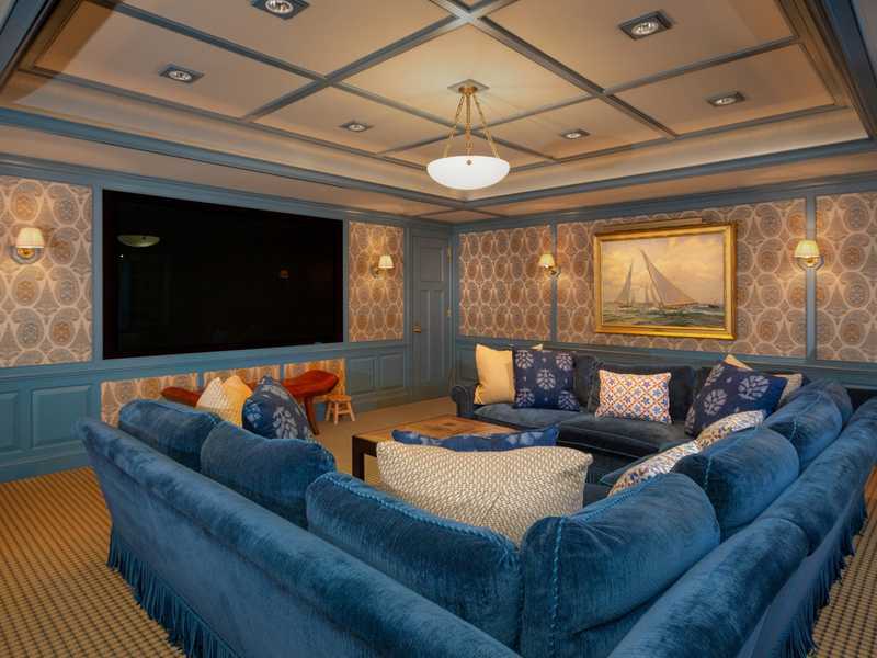 107 Long Neck Point Road Darien, CT 06820 - Photo 18 of 25 a living room with furniture a large window and a flat screen tv