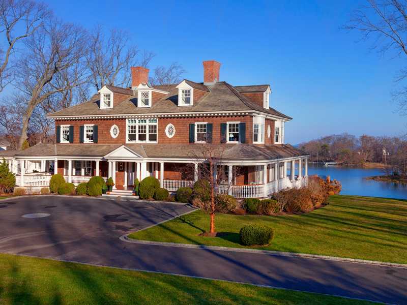 107 Long Neck Point Road Darien, CT 06820 - Photo 2 of 25 a front view of a house with garden