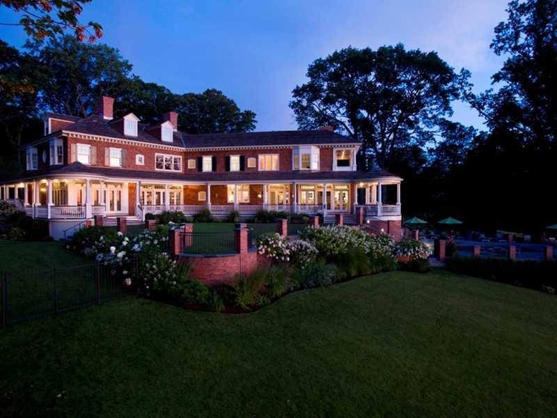 107 Long Neck Point Road Darien, CT 06820 - Photo 24 of 25 a view of a house next to a yard with plants and trees
