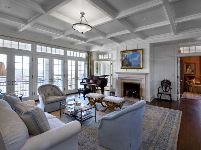 107 Long Neck Point Road Darien, CT 06820 - Photo 8 of 25 a living room with furniture a fireplace and a large window